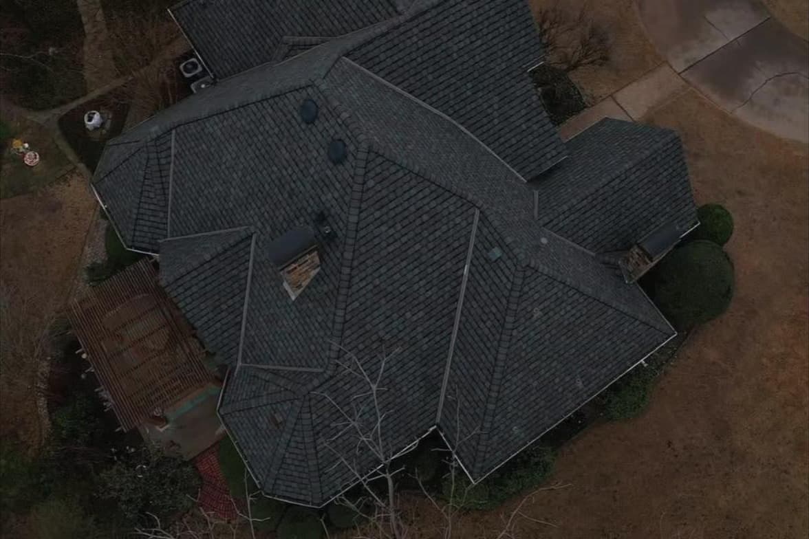Overhead drone view of a designer shingle roof on a large custom home